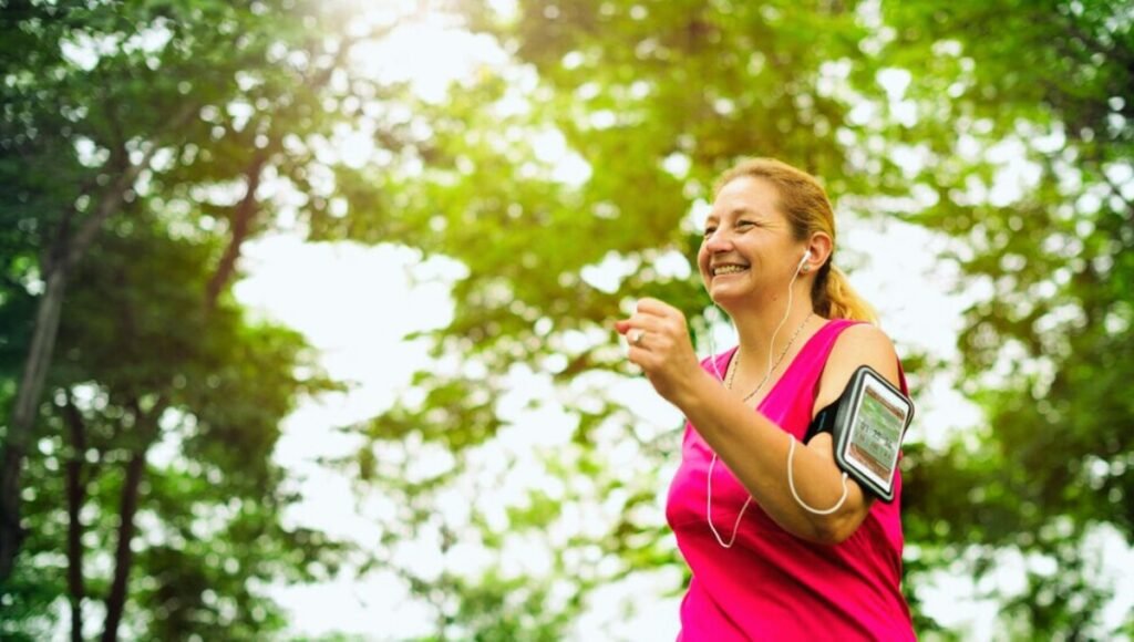 healthy life wellhealthorganic, a woman running with earphones and armband